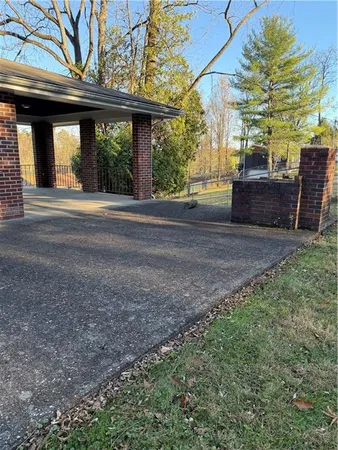 a view of a house with backyard and a tree