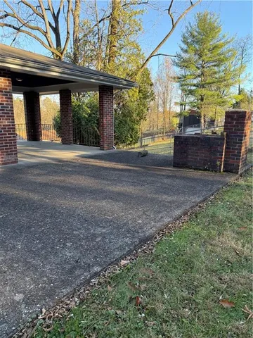 a view of a house with backyard and a tree