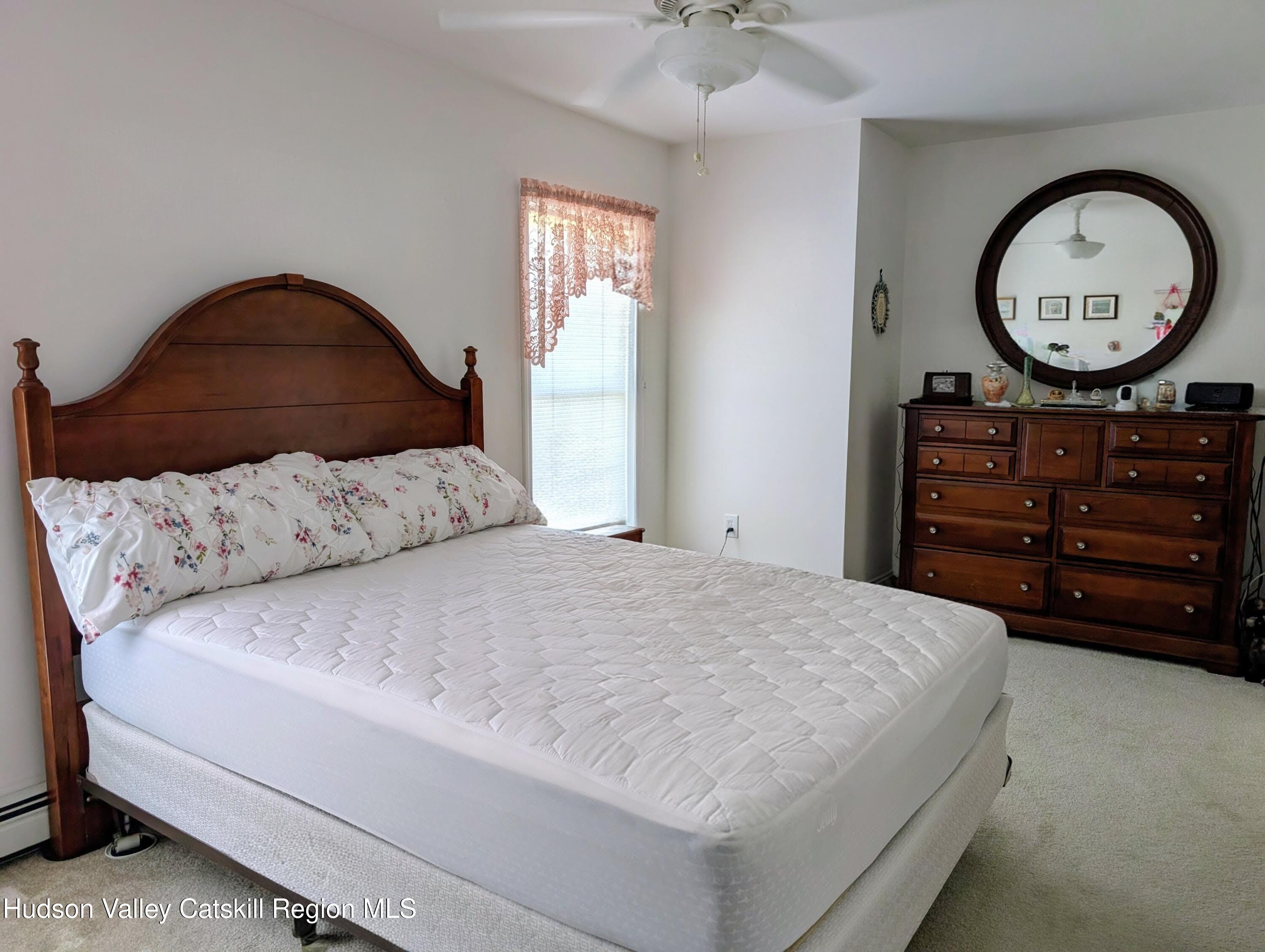 834 Co Rte 19 Elizaville, NY 12523 - Photo 11 of 32 a bedroom with a bed a mirror and a window