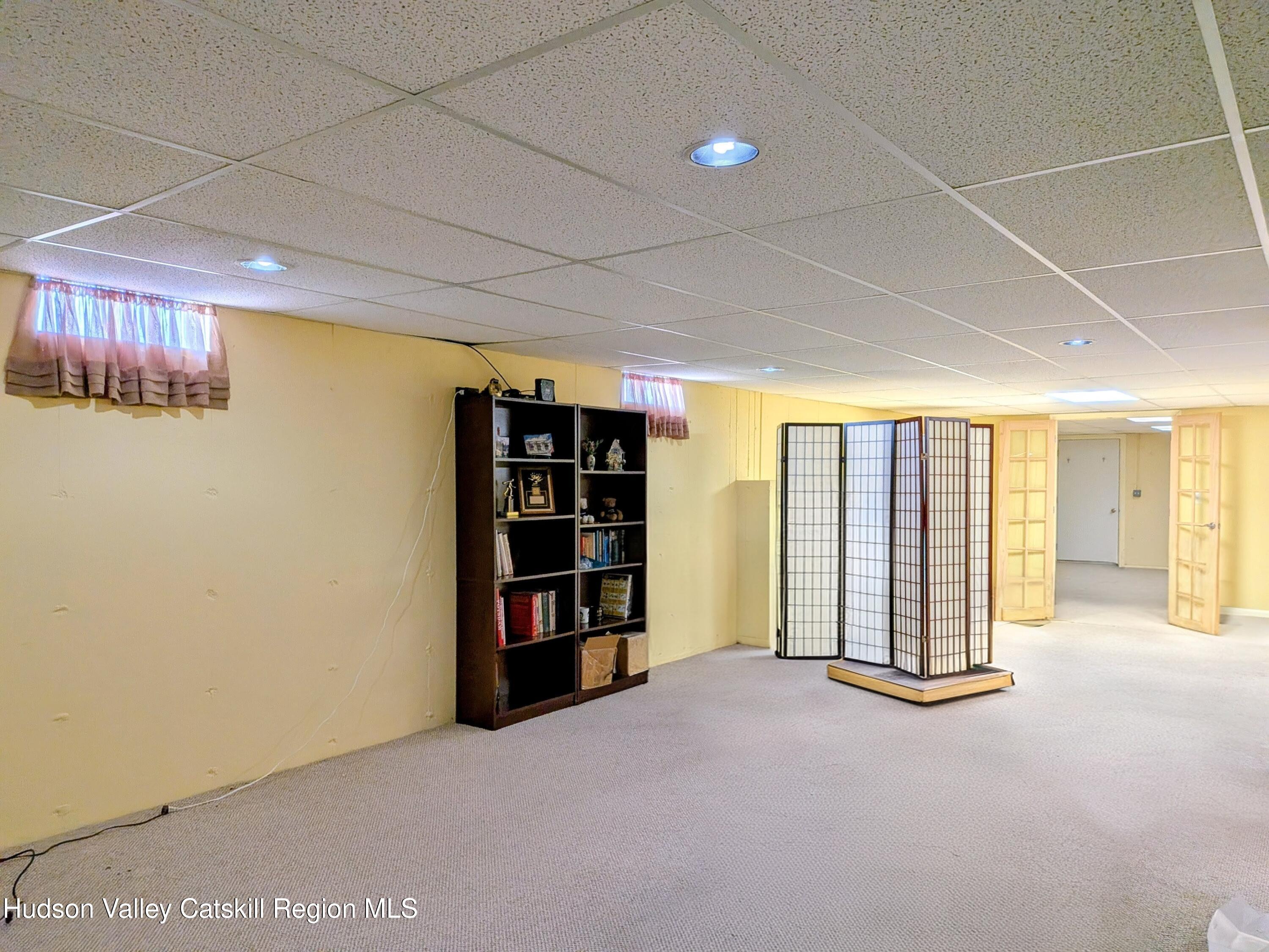 834 Co Rte 19 Elizaville, NY 12523 - Photo 17 of 32 an empty room with bookshelf and a window