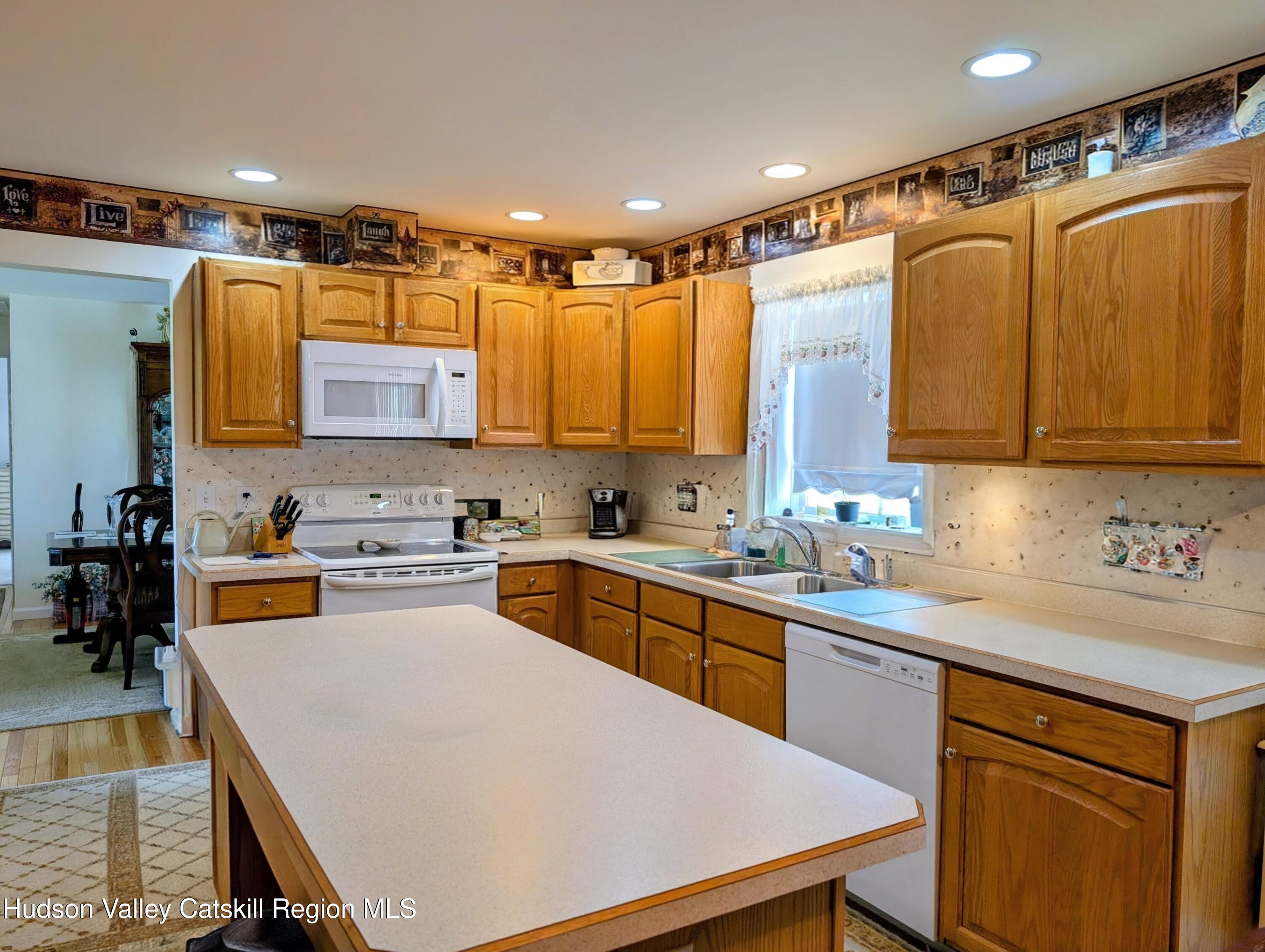 834 Co Rte 19 Elizaville, NY 12523 - Photo 3 of 32 a kitchen with stainless steel appliances granite countertop a sink refrigerator and cabinets