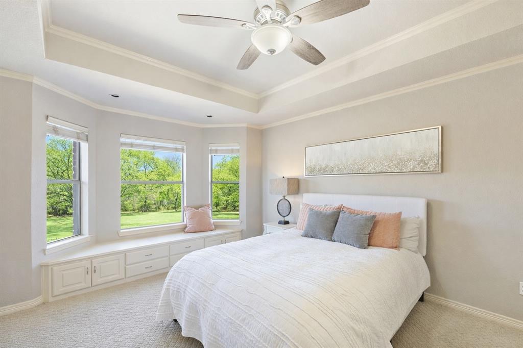 1520 Snider Court Lucas, TX 75002 - Photo 27 of 40 The spacious secondary bedroom has an ensuite and is on the second floor and features a large bay window, neutral tones, and plenty of natural light—ideal for guests or family. Notice the cozy window seat—perfect for relaxing!