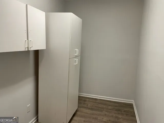 a view of a room with wooden floor