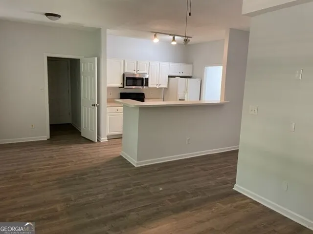 a kitchen with stainless steel appliances a refrigerator and a stove top oven