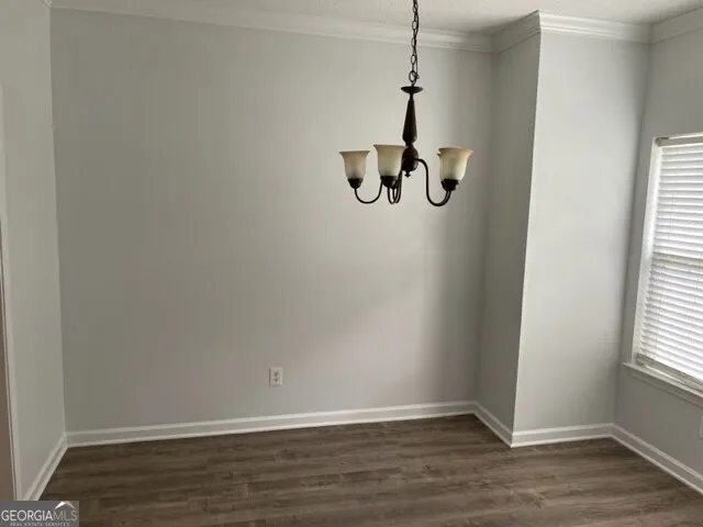 a view of a hardwood floor and window in a room