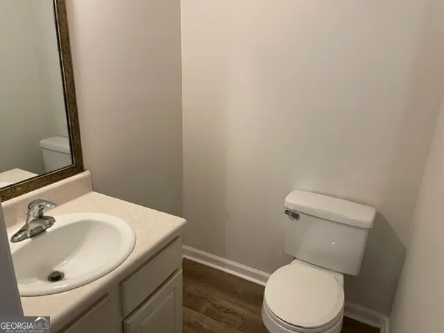 a white toilet sitting next to a bathroom sink