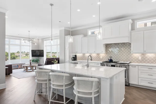 a view of cabinets a sink and a stove in a room
