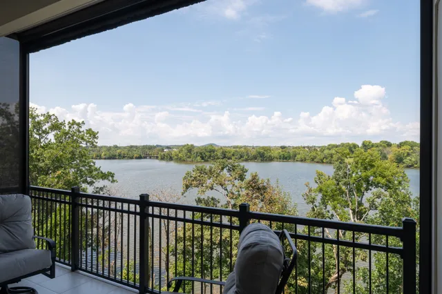 an aerial view of a house with outdoor space and lake view
