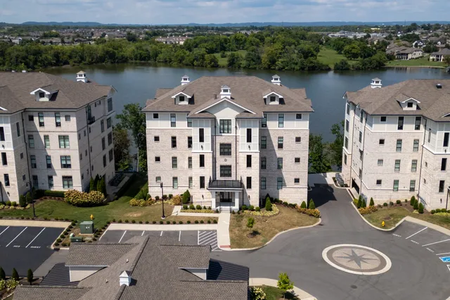 an aerial view of a house with outdoor space and lake view