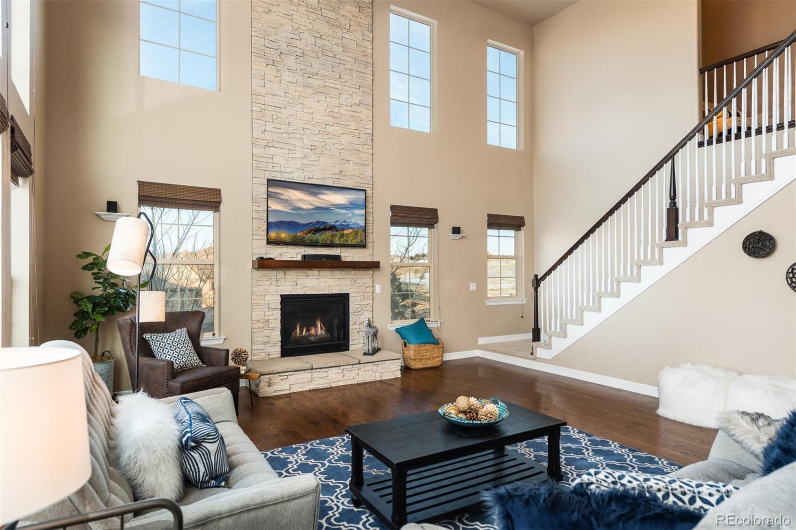 10868 Sundial Rim Road Highlands Ranch, CO 80126 - Photo 3 of 30 a living room with furniture fireplace and a flat screen tv