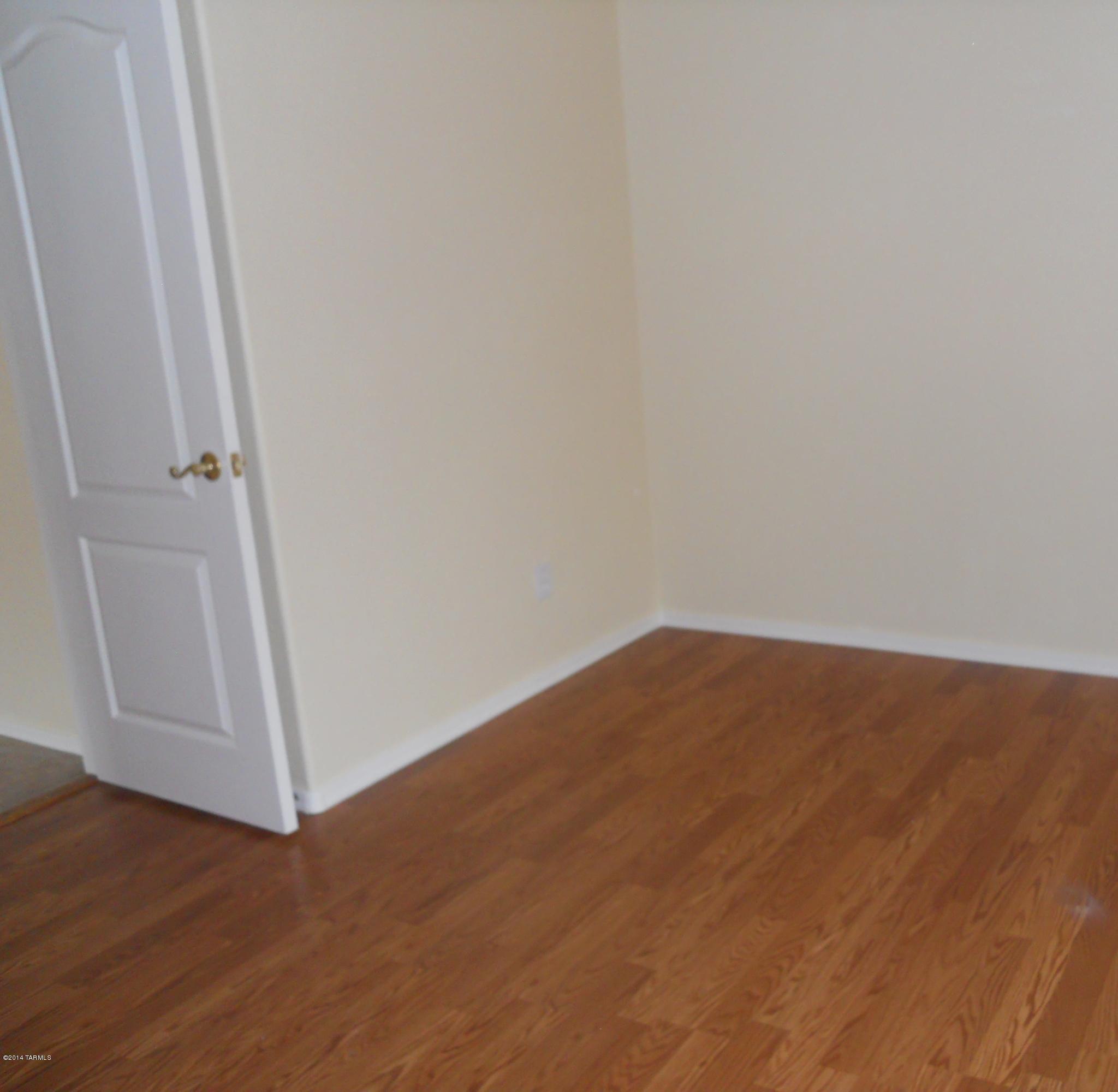 7736 East Elk Creek Road Tucson, AZ 85750 - Photo 7 of 11 a view of empty room with wooden floor