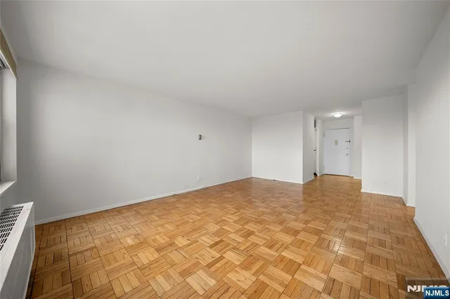 a kitchen with stainless steel appliances a white table and chairs in it