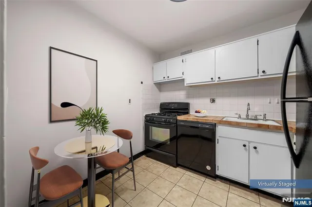 a kitchen with a refrigerator stove and cabinets