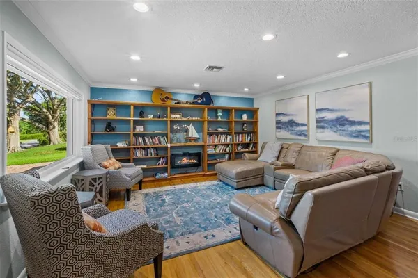 a living room with furniture and a book shelf