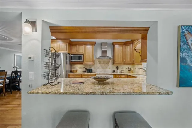 a bathroom with sink granite counter and glass door