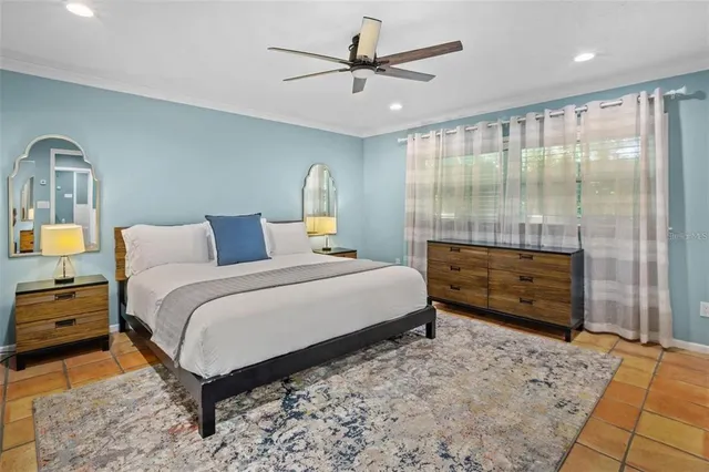 a bedroom with a bed and a window