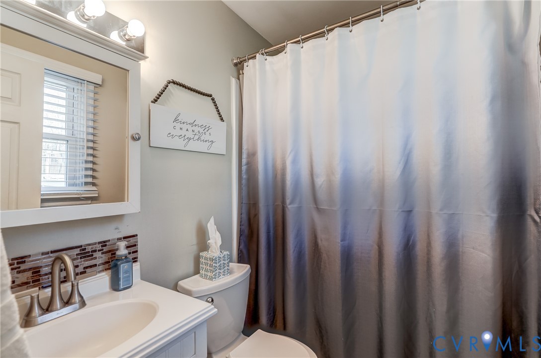 20903 Matoaca Road Petersburg, VA 23803 - Photo 20 of 42 a white toilet sitting next to a bathroom sink