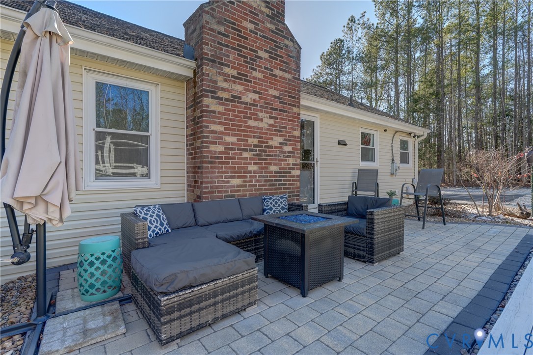 20903 Matoaca Road Petersburg, VA 23803 - Photo 24 of 42 a view of a patio with couches and a table and chairs with wooden floor