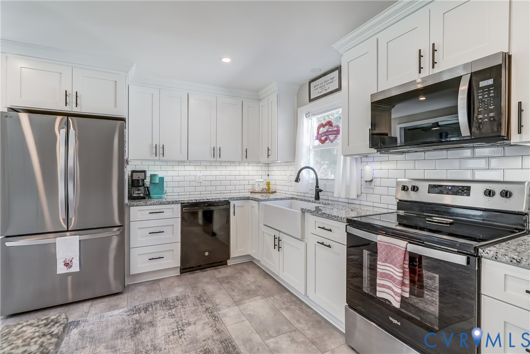 20903 Matoaca Road Petersburg, VA 23803 - Photo 4 of 42 a kitchen with stainless steel appliances a stove sink and microwave