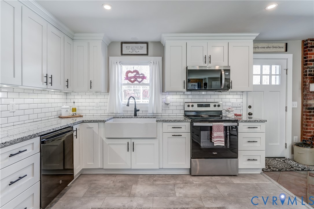 20903 Matoaca Road Petersburg, VA 23803 - Photo 5 of 42 a kitchen with stainless steel appliances granite countertop a stove sink and microwave