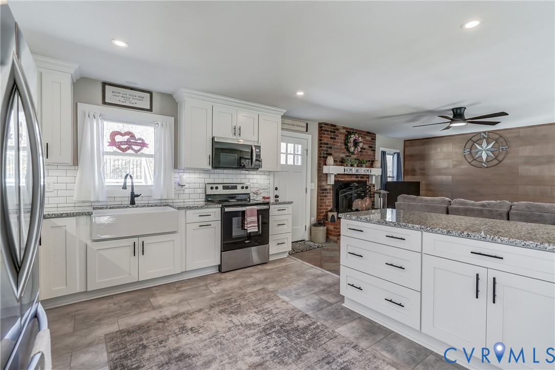 20903 Matoaca Road Petersburg, VA 23803 - Photo 9 of 42 a kitchen with granite countertop a sink stainless steel appliances and cabinets