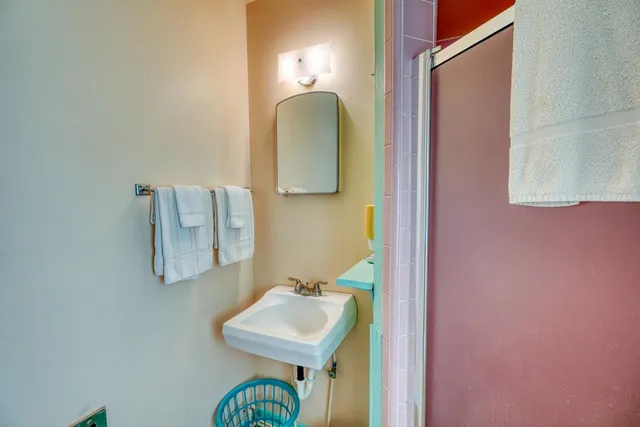 a bathroom with a toilet sink and mirror