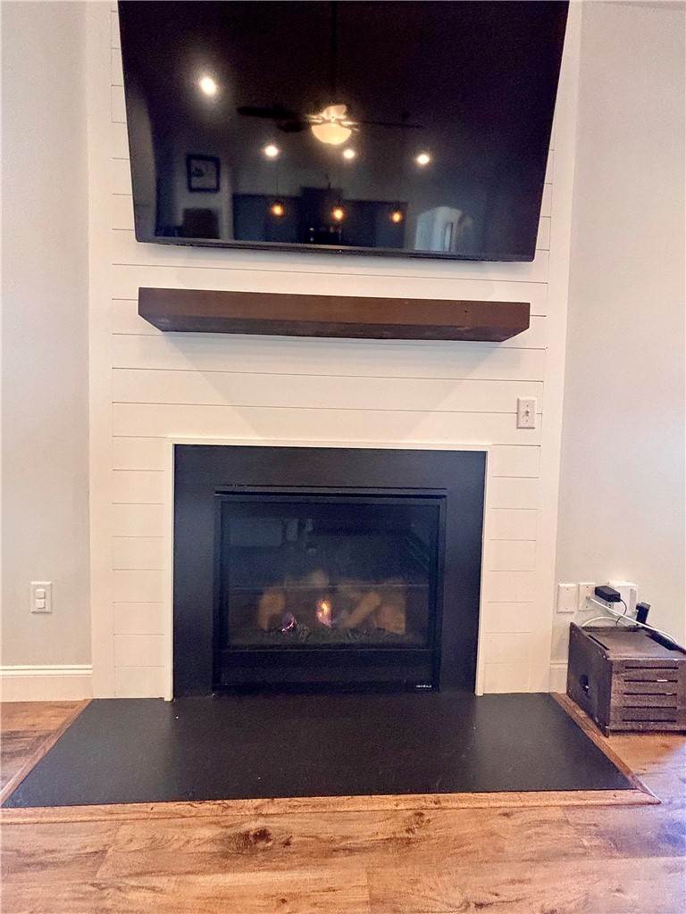 248 Inlet Pointe Drive Anderson, SC 29625 - Photo 12 of 42 This living room features a fireplace, shiplap accent wall, and wood flooring, perfect for cozy gatherings.