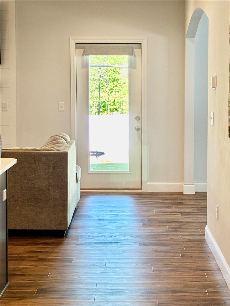 248 Inlet Pointe Drive Anderson, SC 29625 - Photo 13 of 42 This inviting interior features elegant flooring and a graceful arched entryway leading to the outdoors.