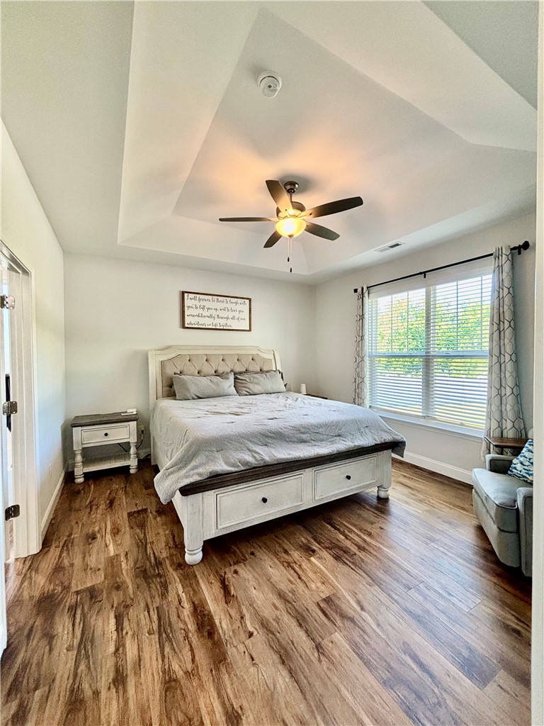 248 Inlet Pointe Drive Anderson, SC 29625 - Photo 15 of 42 This spacious bedroom features elegant wood flooring and a beautiful tray ceiling.