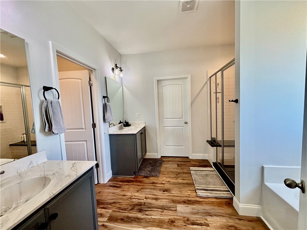 248 Inlet Pointe Drive Anderson, SC 29625 - Photo 17 of 42 This spacious bathroom offers elegant dual vanities and a large glass-enclosed shower.