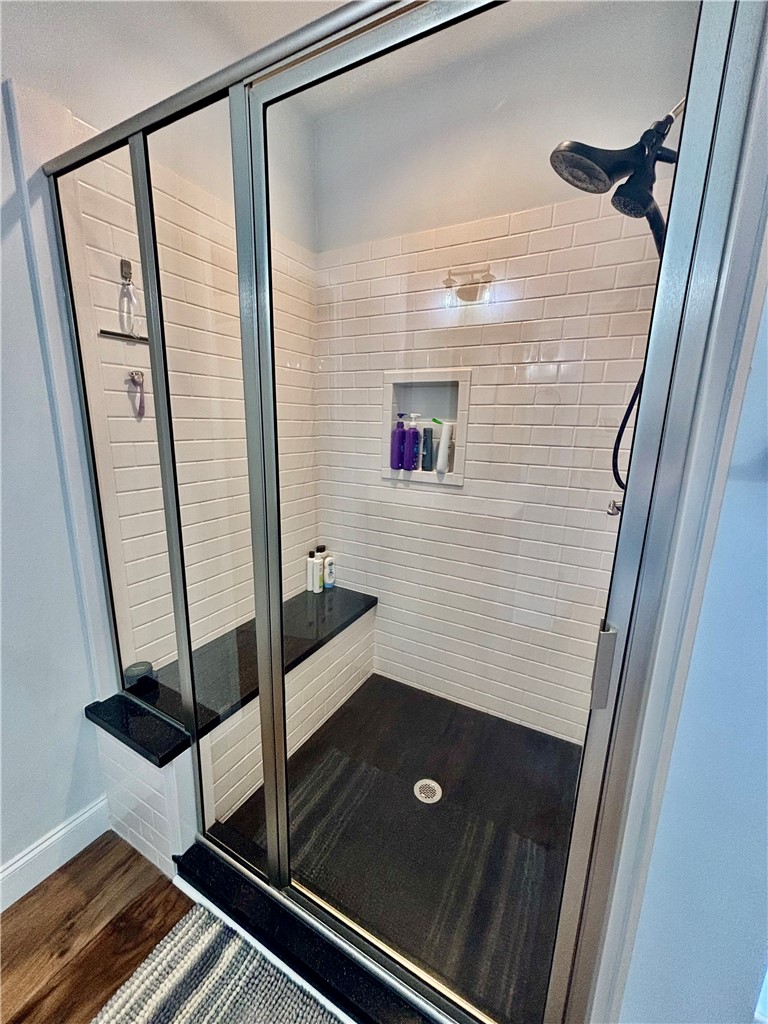 248 Inlet Pointe Drive Anderson, SC 29625 - Photo 19 of 42 This sleek shower features modern tiling and a built-in bench for enhanced comfort and style.