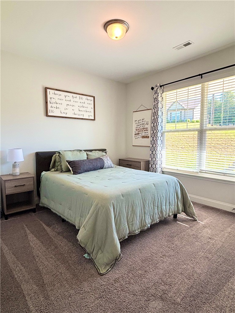 248 Inlet Pointe Drive Anderson, SC 29625 - Photo 21 of 42 This inviting 2nd bedroom features soft carpeting and ample natural light.