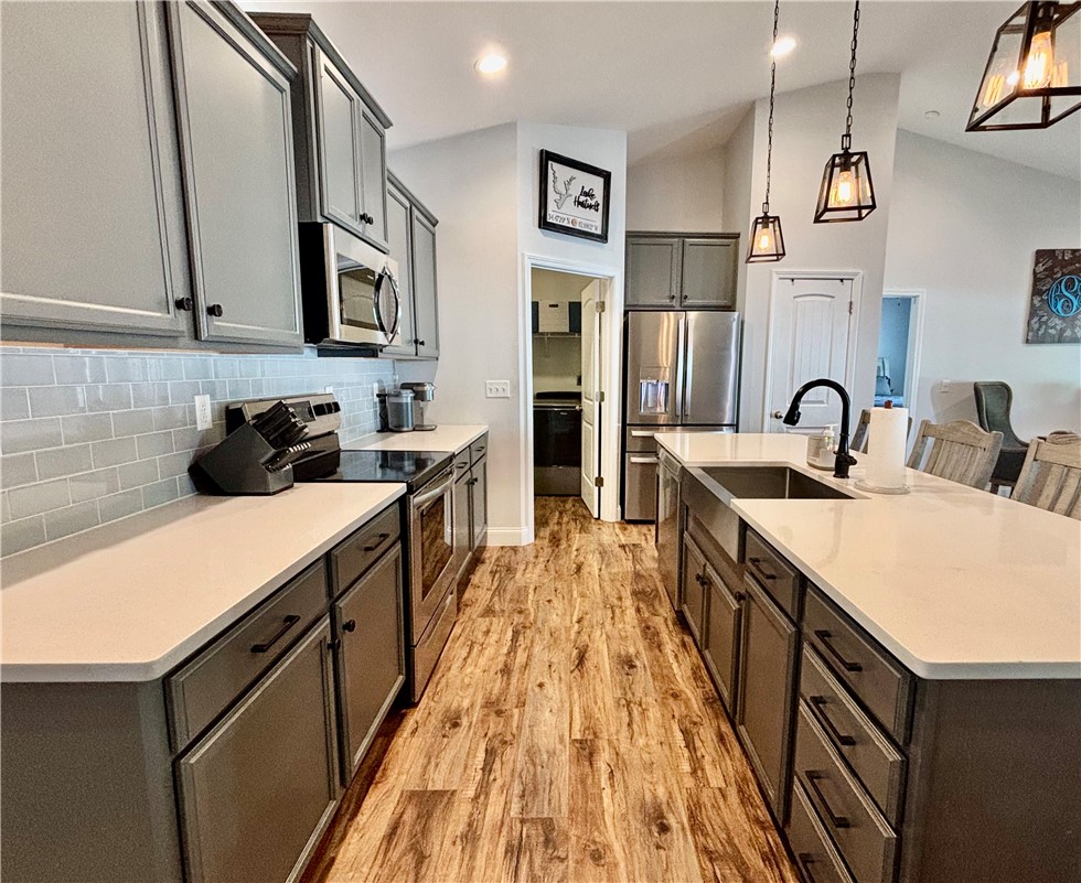 248 Inlet Pointe Drive Anderson, SC 29625 - Photo 6 of 42 This contemporary kitchen features high ceilings, an island with a sink, and stainless steel appliances.