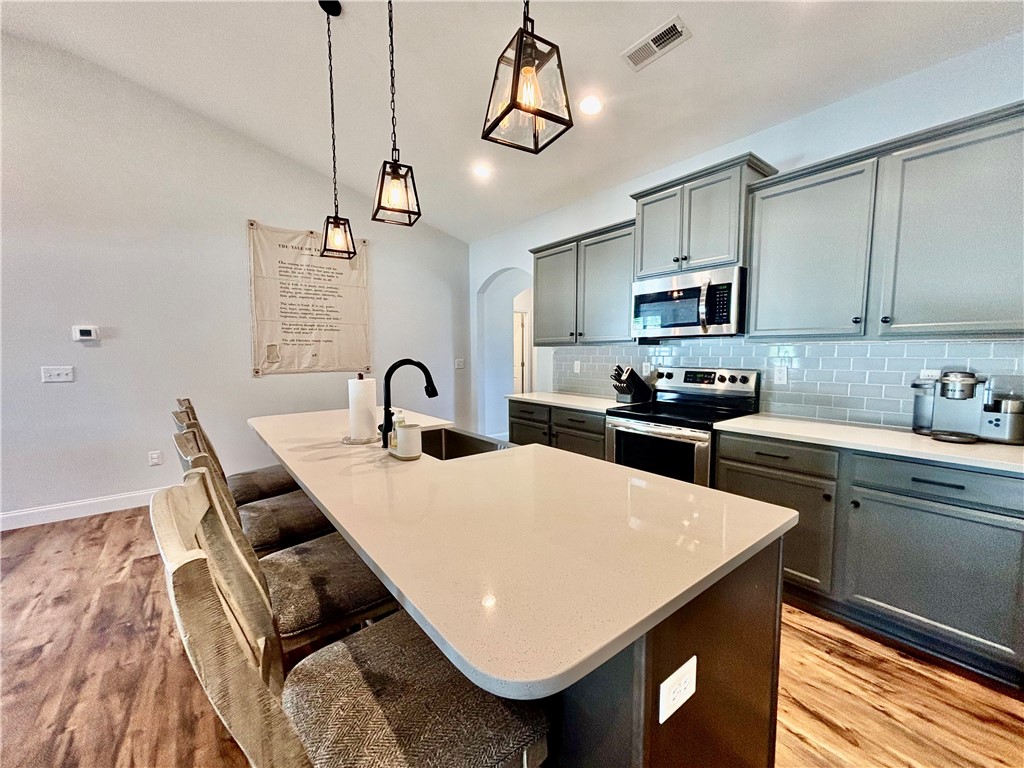 248 Inlet Pointe Drive Anderson, SC 29625 - Photo 7 of 42 This modern kitchen features a spacious island and contemporary appliances, perfect for everyday living.
