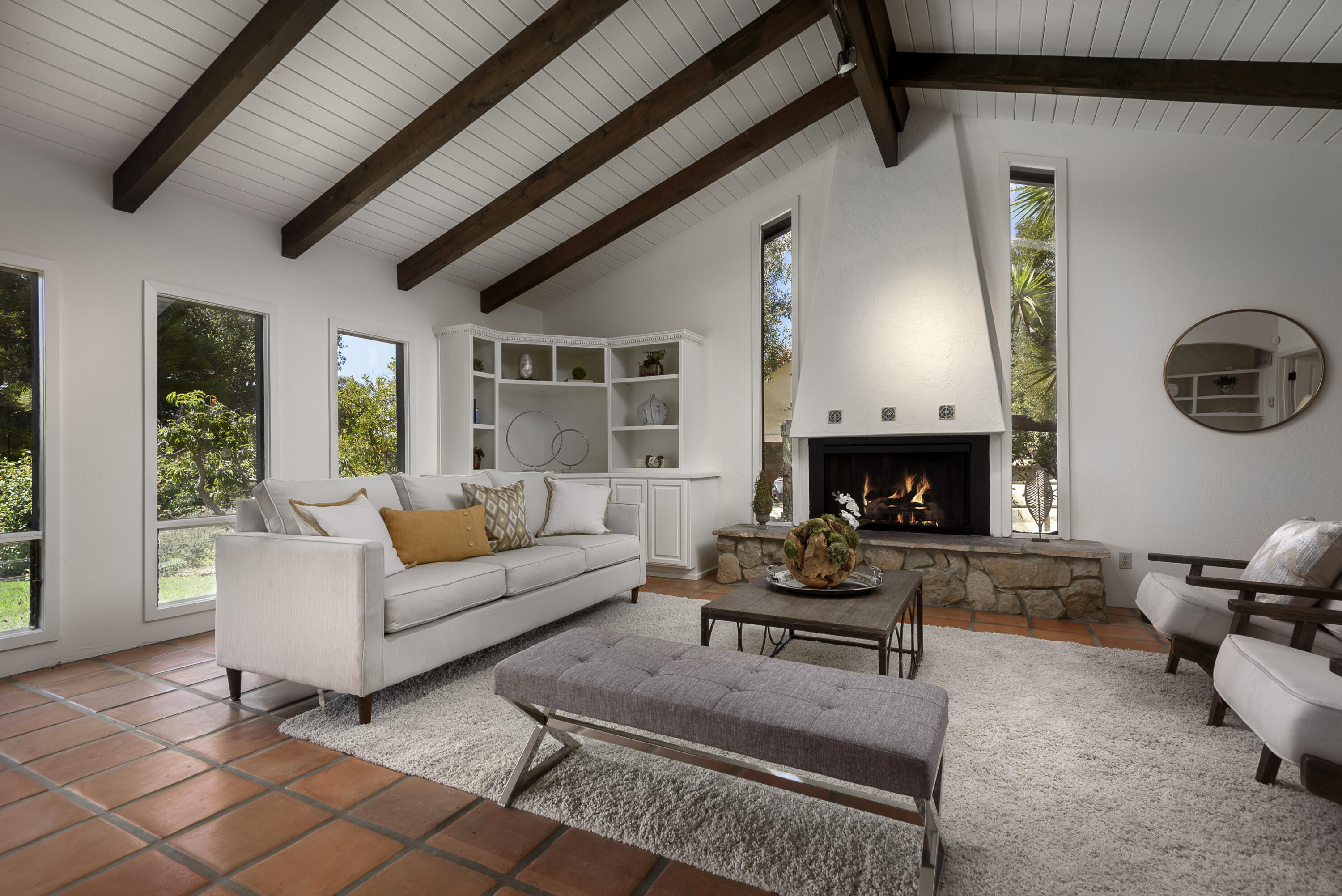 1040 Ladera Lane Montecito, CA 93108 - Photo 2 of 18 a living room with furniture a fireplace and a large window
