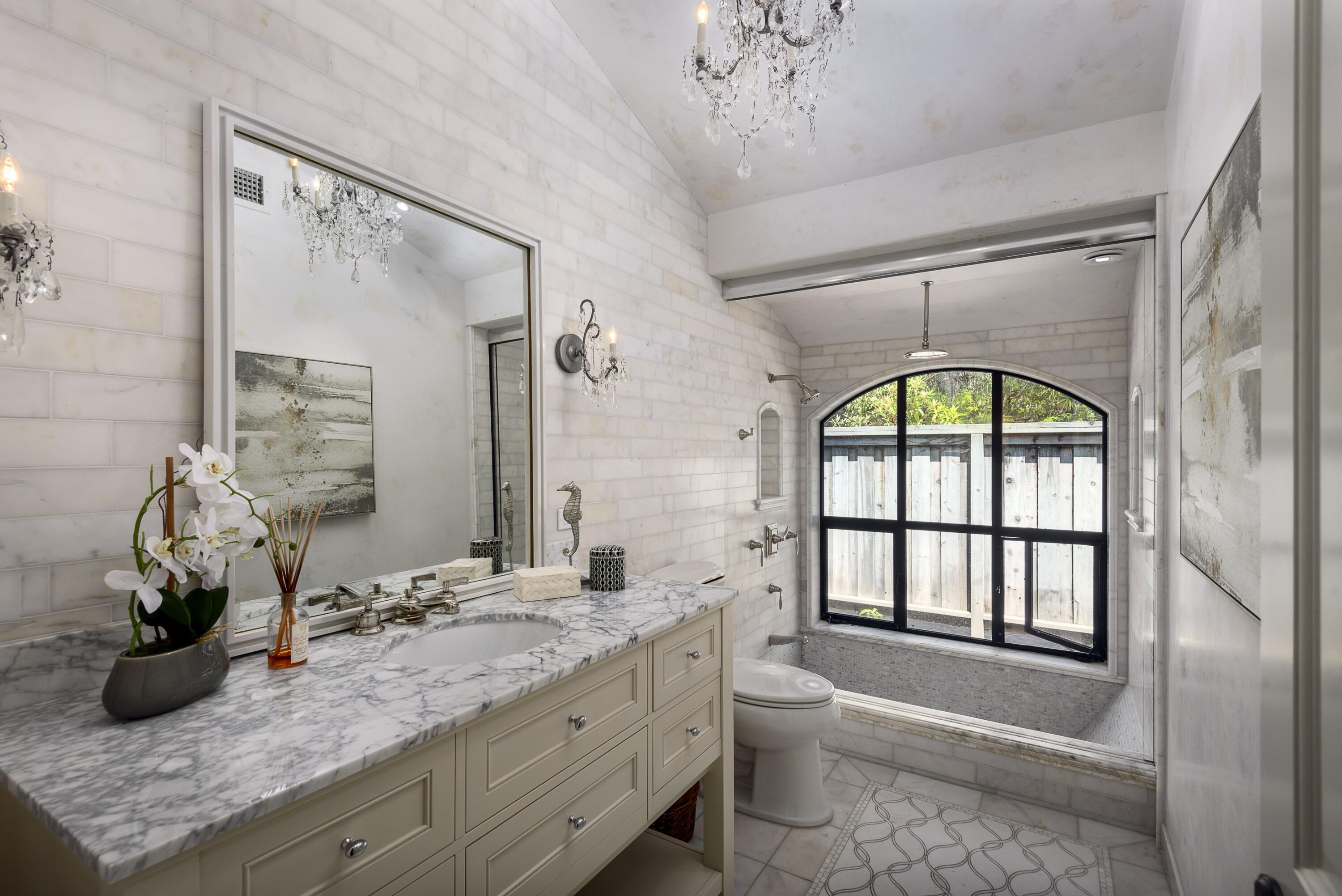 1040 Ladera Lane Montecito, CA 93108 - Photo 9 of 18 a bathroom with a granite countertop sink a large mirror and a bathtub