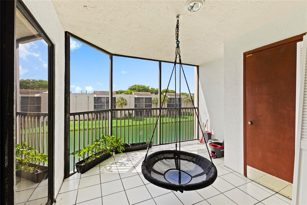 3199 Foxcroft Road, Unit 304 Miramar, FL 33025 - Photo 16 of 23 a view of a balcony with a swimming pool