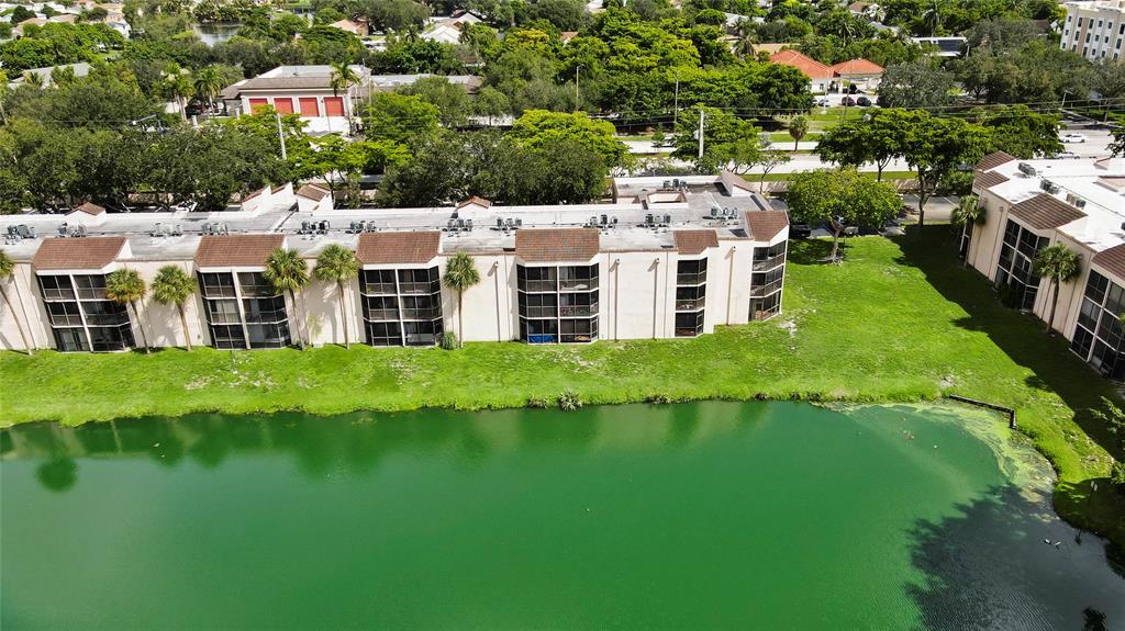3199 Foxcroft Road, Unit 304 Miramar, FL 33025 - Photo 19 of 23 a large body of water with a building in the background