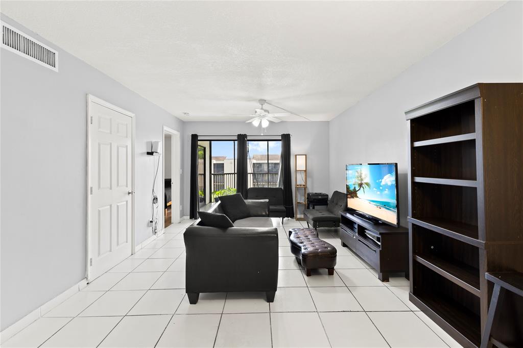 3199 Foxcroft Road, Unit 304 Miramar, FL 33025 - Photo 8 of 23 a living room with furniture cabinets and a walk in closet