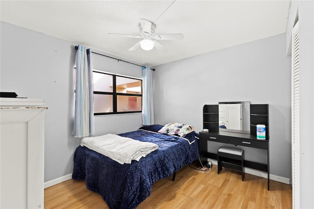 3199 Foxcroft Road, Unit 304 Miramar, FL 33025 - Photo 10 of 23 a bedroom with a bed window and a flat screen tv