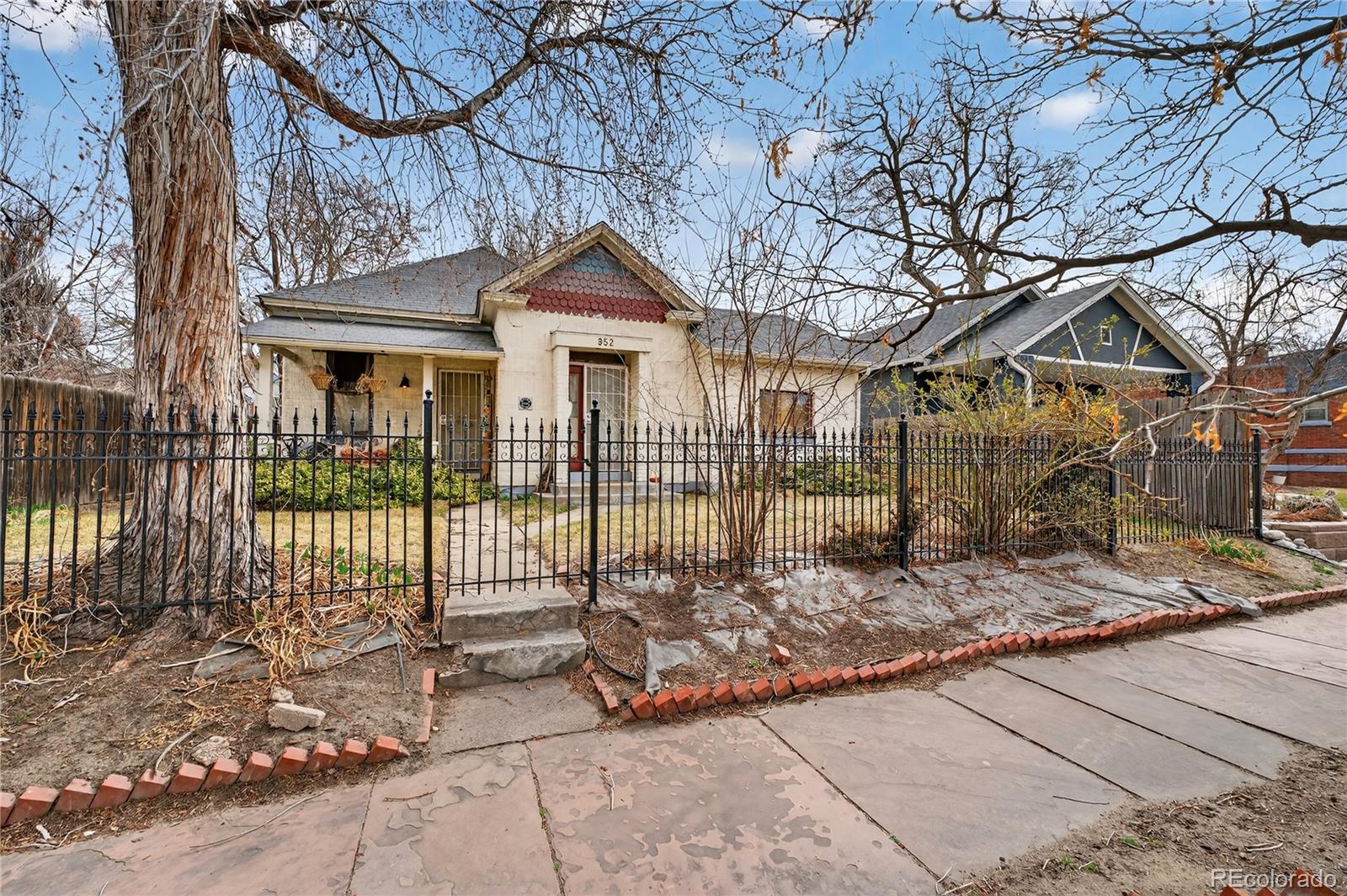 352 Bannock Street Denver, CO 80223 - Photo 1 of 43 a front view of a house with a yard