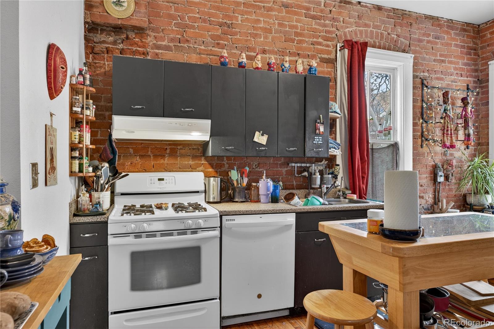 352 Bannock Street Denver, CO 80223 - Photo 9 of 43 a kitchen with a stove and a microwave