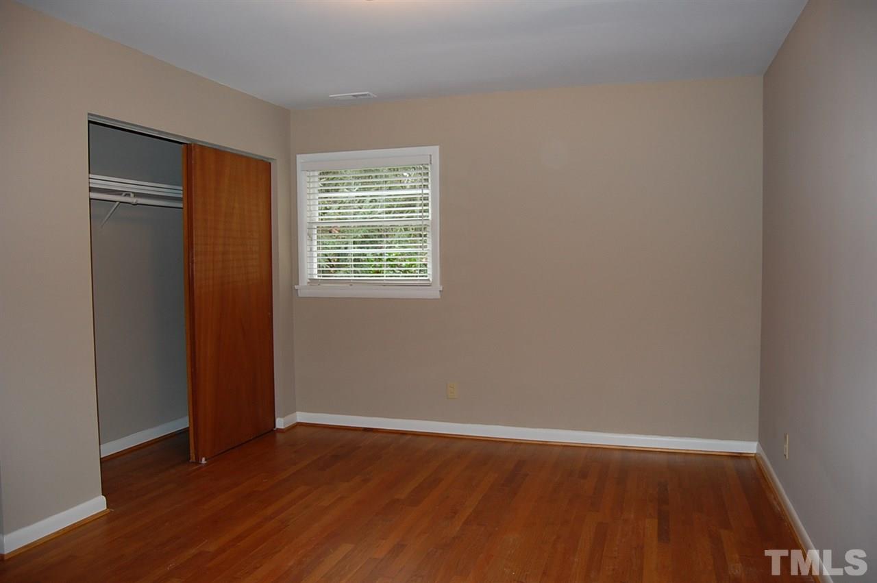 3214 Cyanne Circle Raleigh, NC 27606 - Photo 13 of 21 an empty room with wooden floor and windows