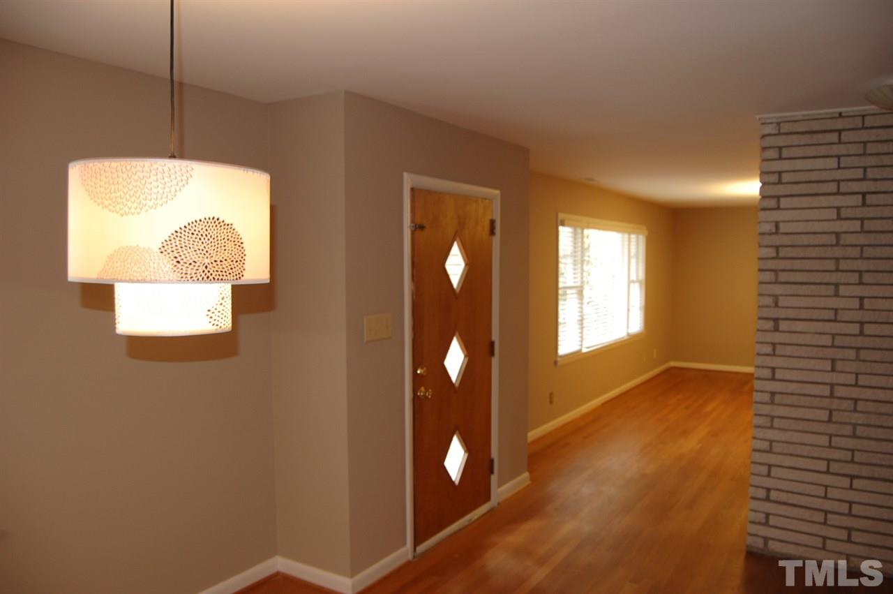 3214 Cyanne Circle Raleigh, NC 27606 - Photo 7 of 21 a view of an empty room with wooden floor and a window