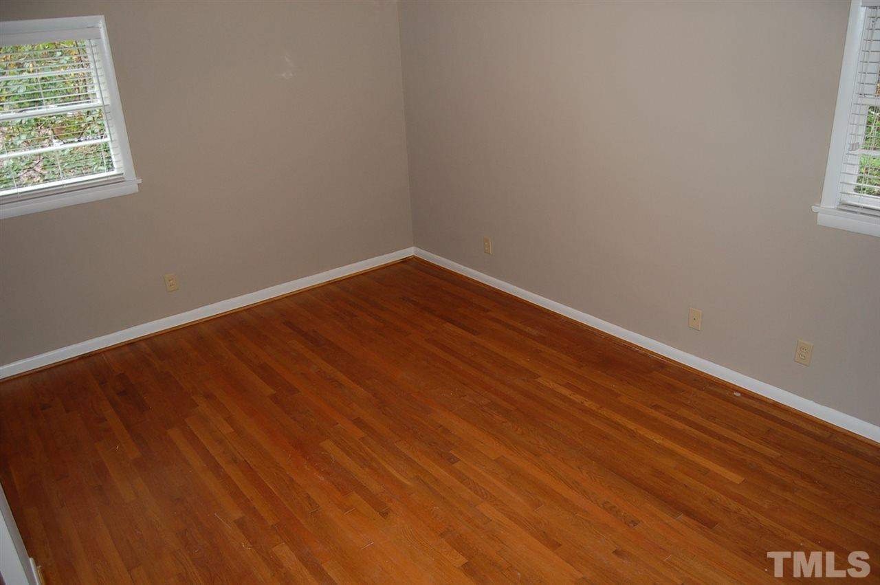 3214 Cyanne Circle Raleigh, NC 27606 - Photo 10 of 21 an empty room with wooden floor and windows