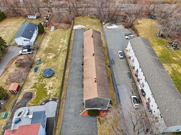 an aerial view of a residential apartment building with a yard
