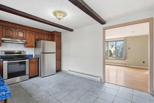 a kitchen with a refrigerator and a stove