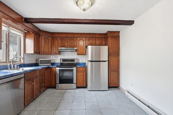 a kitchen with a sink and a refrigerator