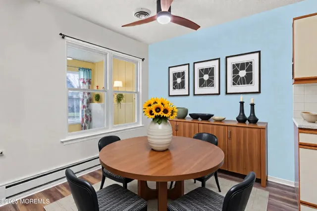 a dining room with furniture and window