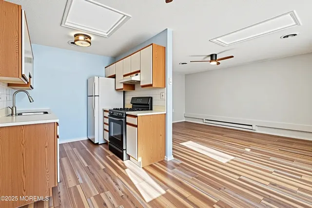 a kitchen with a refrigerator and a stove